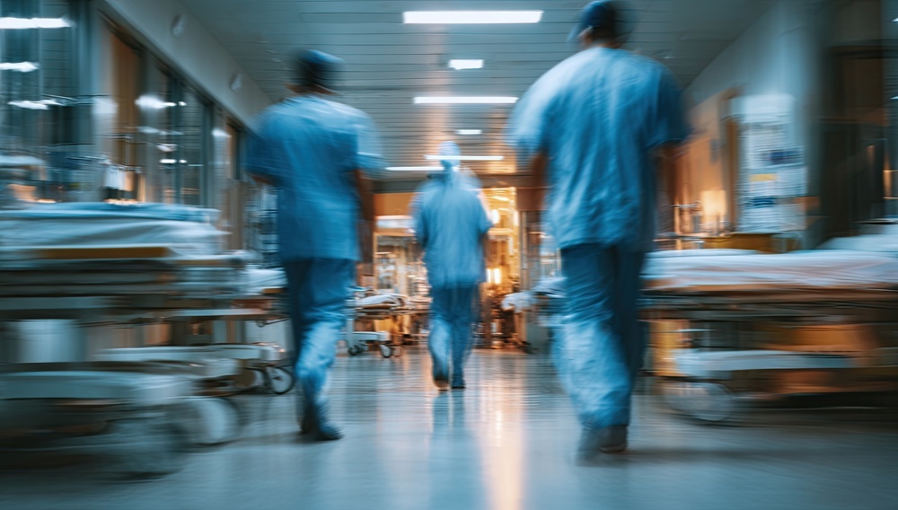 Blurred hospital corridor with medical personnel walking away